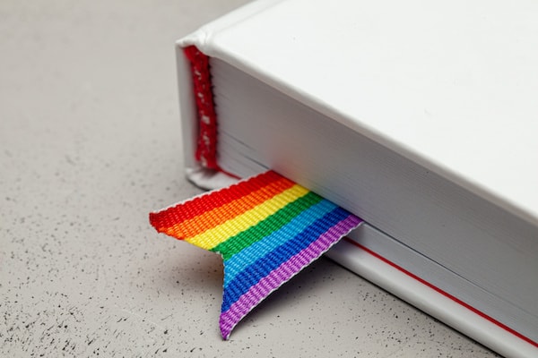 A book with a rainbow ribbon bookmark