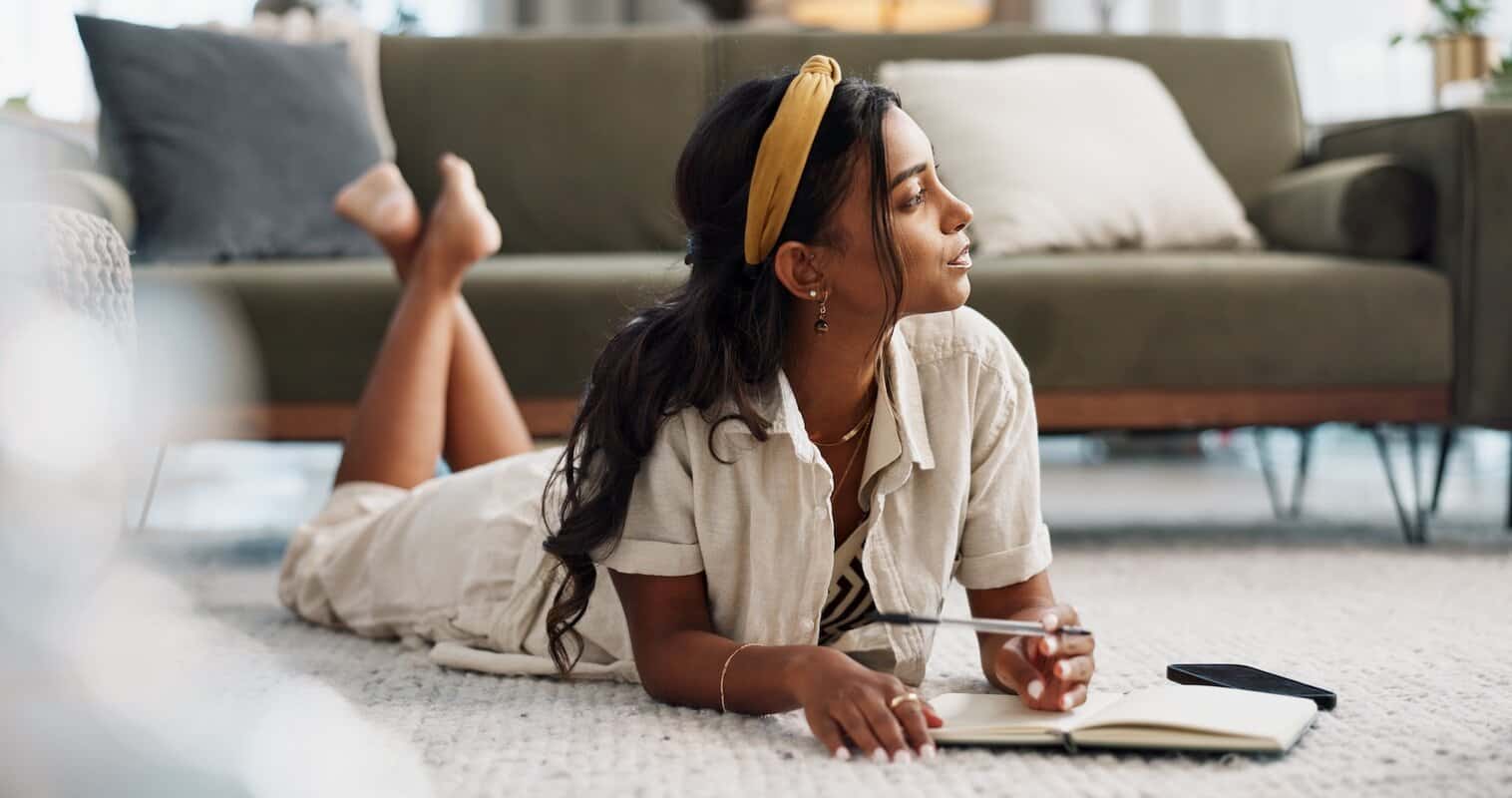A girl contemplating what to write in her reading journal.