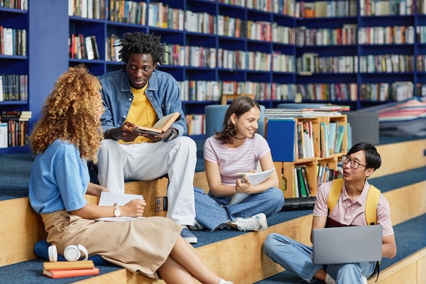 A group of young people sharing ideas as they study in a local library.
